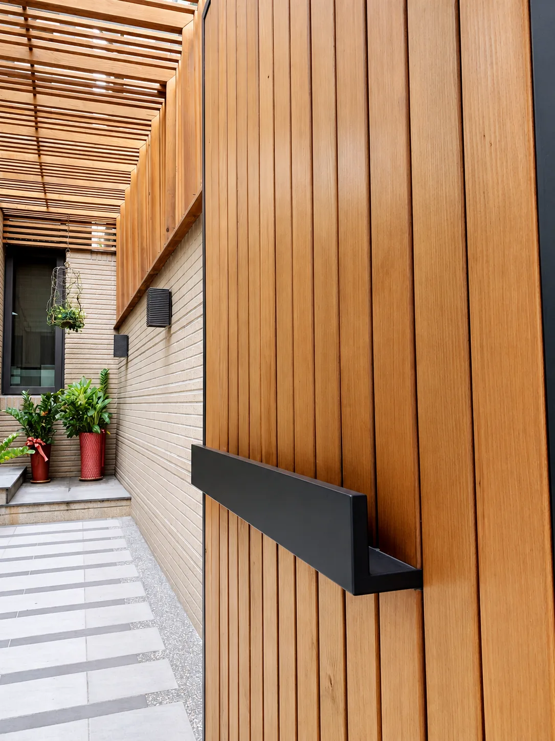 Timber entrance door with a black handle at the GRANDWIN office